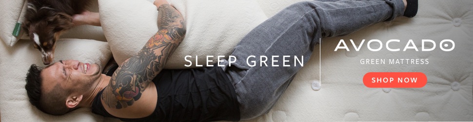 man laying on natural green bed with dog