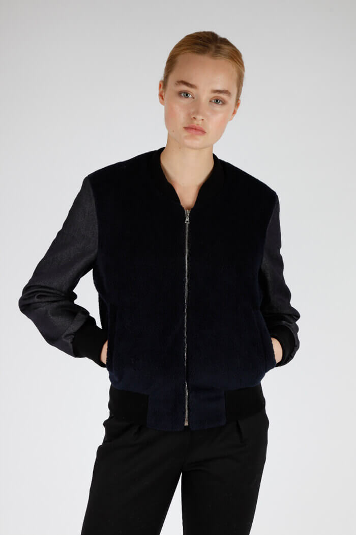 Christopher Raeburn Navy Bomber: This piece is constructed of premium fleece and denim and made locally in Raeburn’s East London studio where he produces many of his collections still by hand.