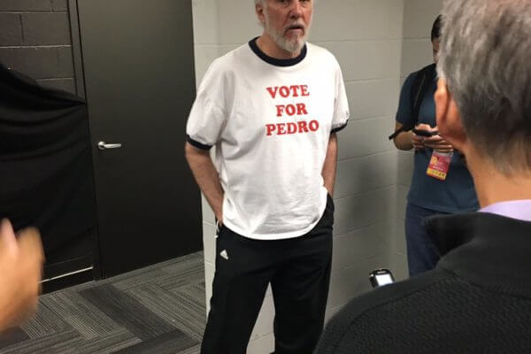 Greg Popovich wearing a Vote for Pedro T-shirt